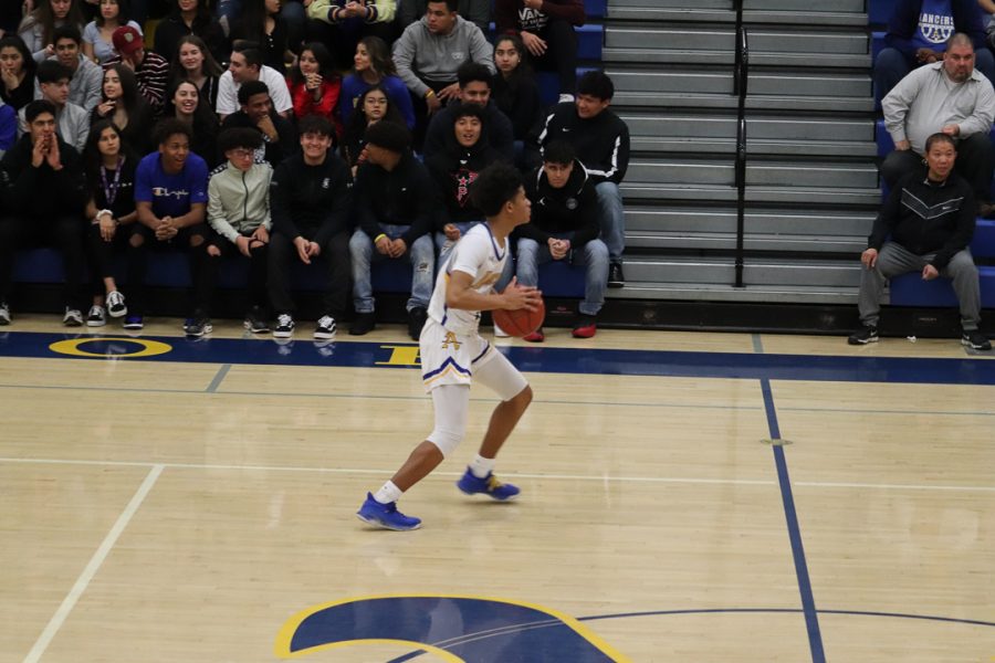 Sophomore Christian Griffin (1)  is bringing  the ball up for Bishop Amat. 