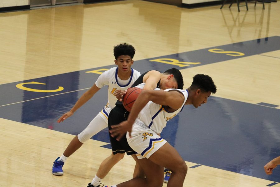 Sophomore Christian Griffin  (1) and  Senior Elijah Ponder  (2) trying to keep the ball with them.