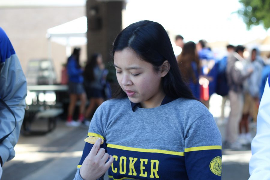 Karina Padilla is trying the lemon girl scout cookies. 