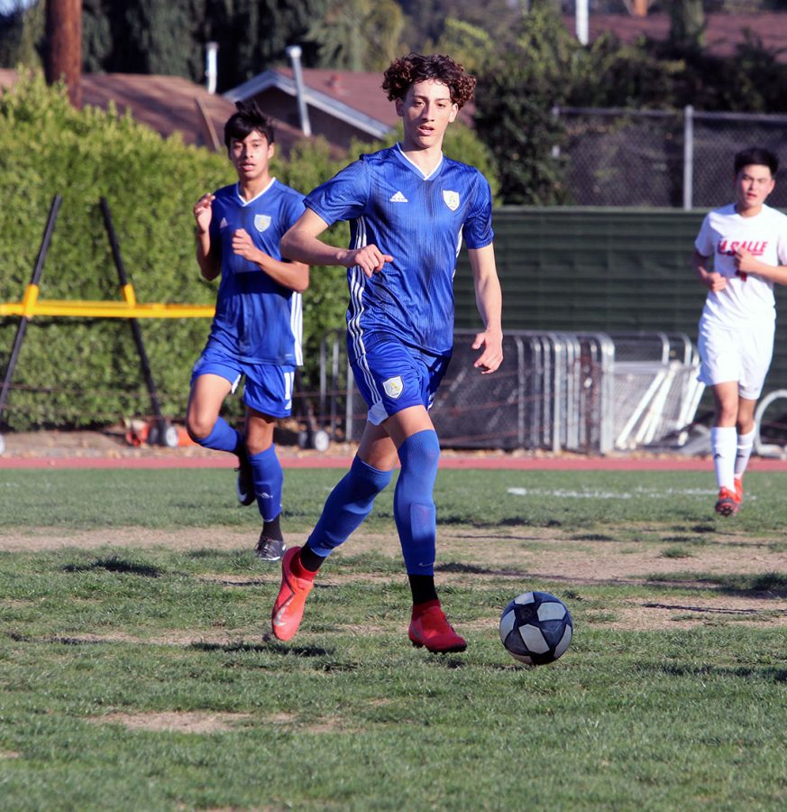 Senior Zachary Luna controls the ball for the Lancers