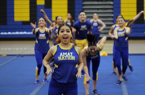 Isabella Correa cheers in front of cheer team.
