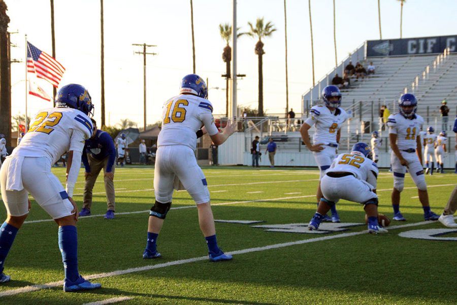 #16 Tobin ODell warming up with teammates while #52 Francisco Molina gets ready to snap the ball. 