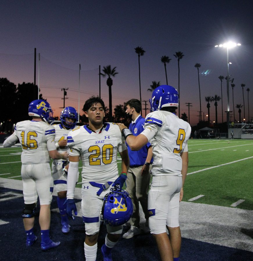 #9 Luke Mcnulty giving his teammate #20 Carlos Alvarez an encouraging pat on the back. 