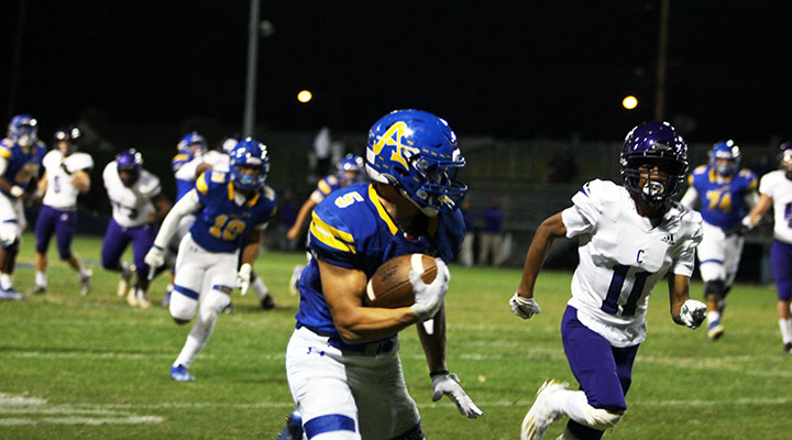 Aiden Ramos on his way to score a touchdown against cathedral game in the kefir stadium.