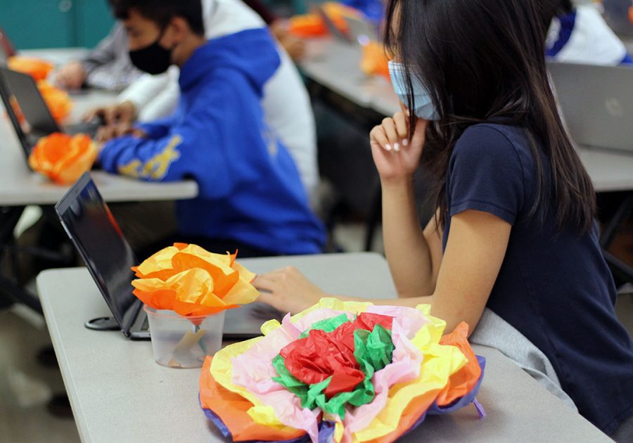 Students get creative in creating their Dia de los Muertos flowers.