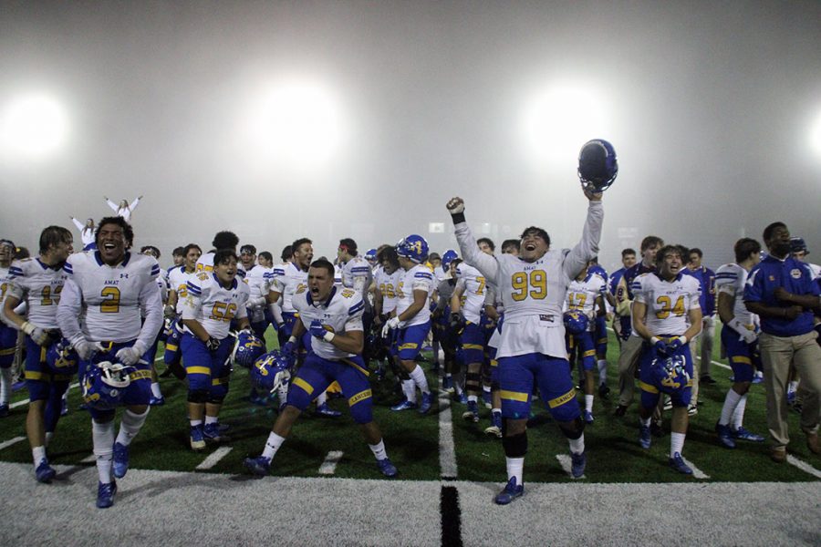 The Lancers celebrate their one-point win against Serra. 