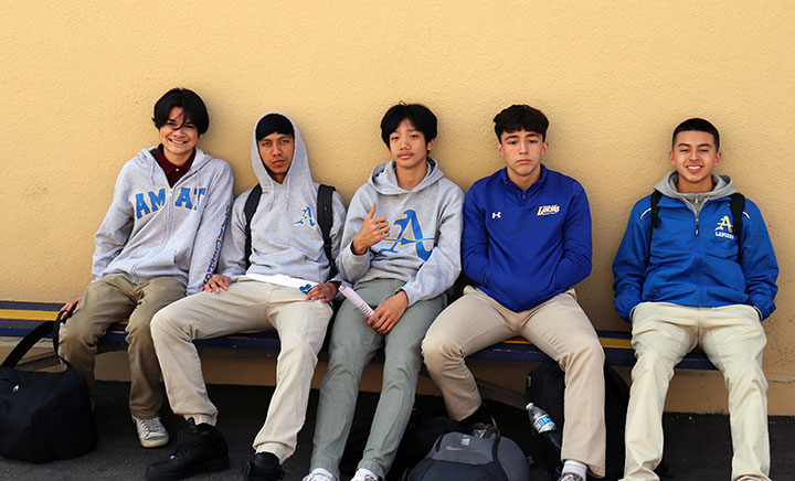 A group of Bishop Amat male students are grouped up together without wearing a face mask. 