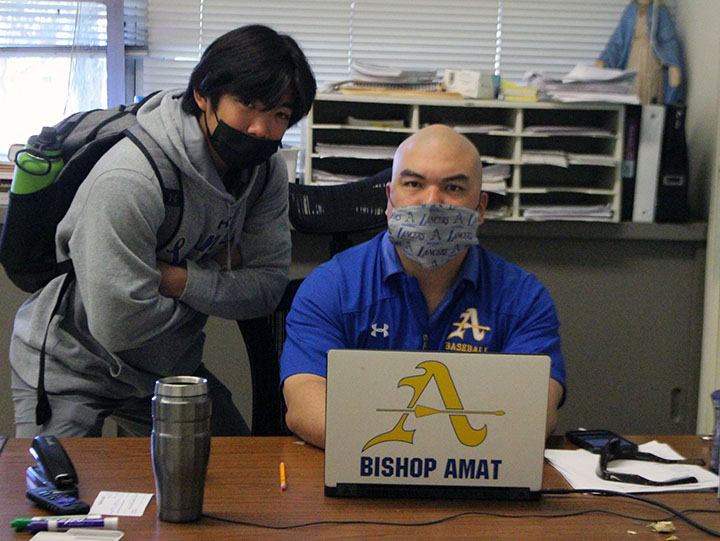 Mr. Hernandez and  A Bishop Amat student are wearing their face mask in Mr.Hernandezs classroom. 