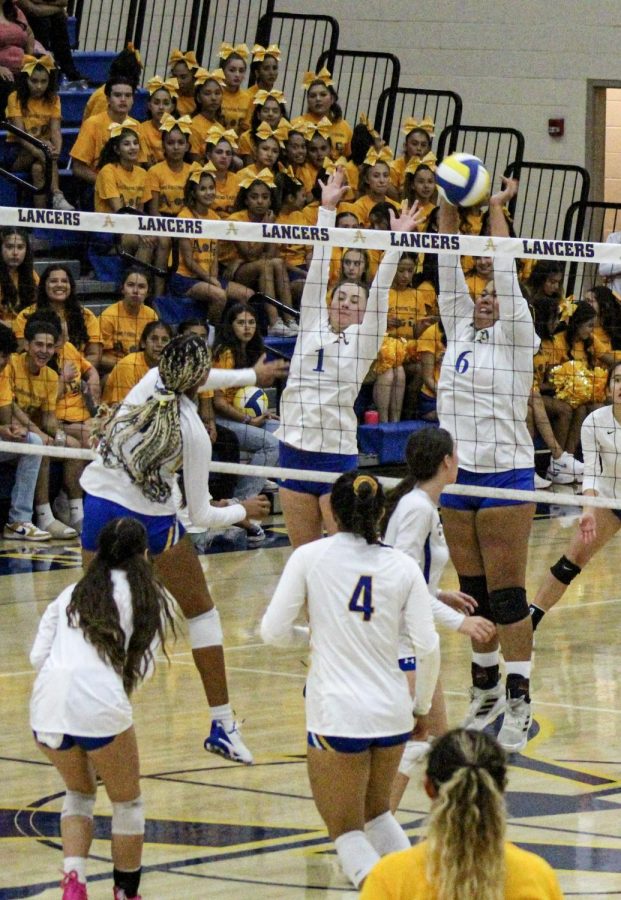 Heather Polich and Emma Cristales blocking a hit from a Charter Oak player. 