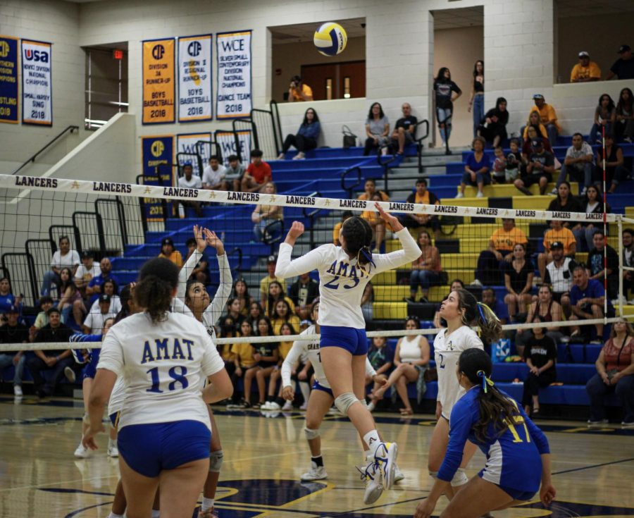 Jessica Estrada jumping to hit the ball. 