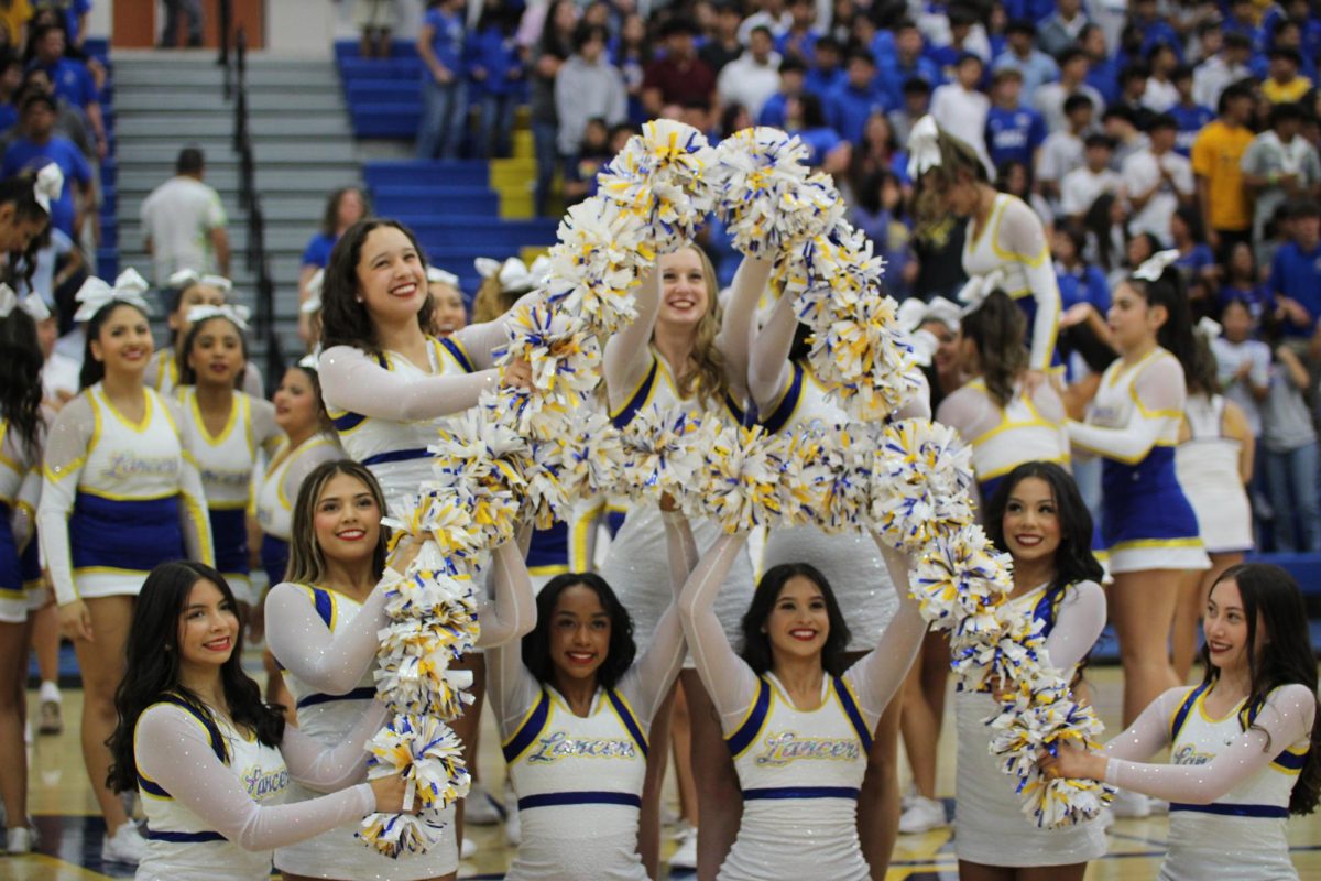 Song+leaders+create+a+Amat+A+with+their+pom+poms+at+Fall+Rally.